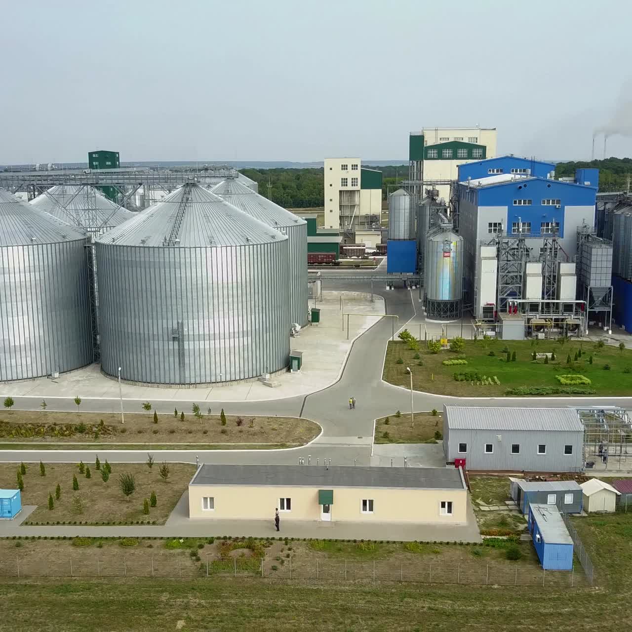 Aerial view. Metal grain elevator in agricultural zone. Grain warehouse
