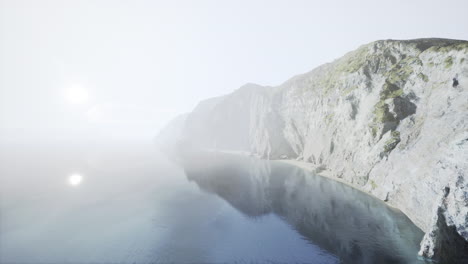 a stunning view of a misty coastline