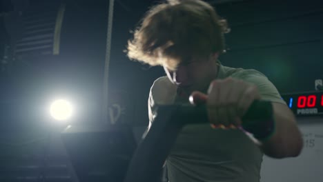 Close-up-of-a-man-doing-exercise-bike-in-the-gym-in-slow-motion