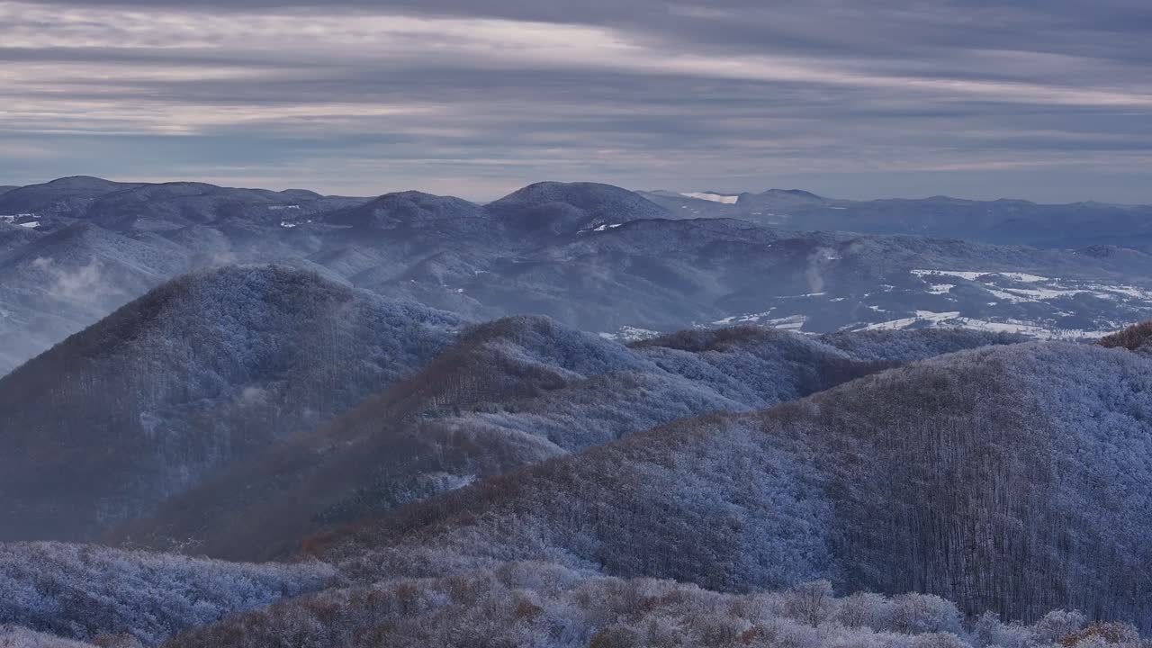 Stunning winter aerial shot of snow-covered mountains, captured from a drone. Perfect for nature, travel, or adventure projects