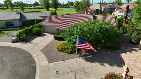 american flag waving in southwestern style neighborhood in usa