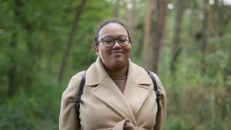 smiling portrait view of black european woman in the forest on her morning walk