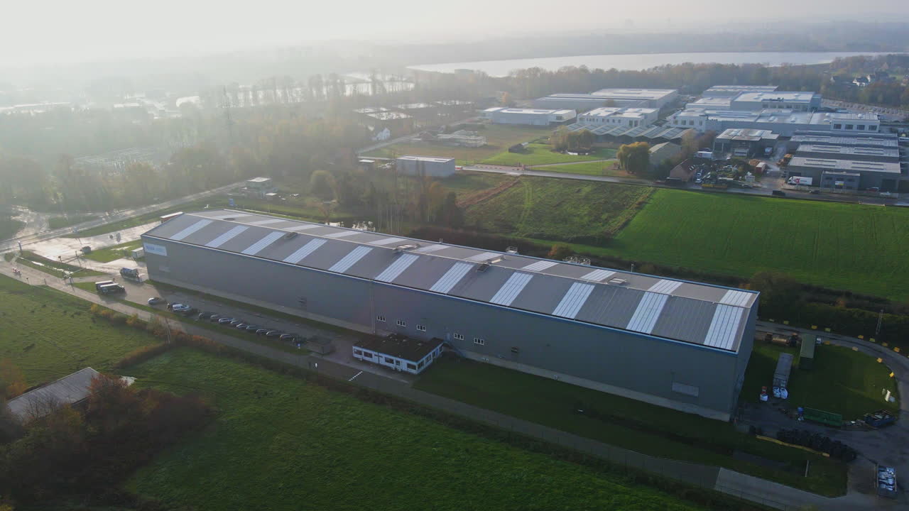 Beautiful aerial of a large industrial factory surrounded by green meadows on a sunny day in Belgium