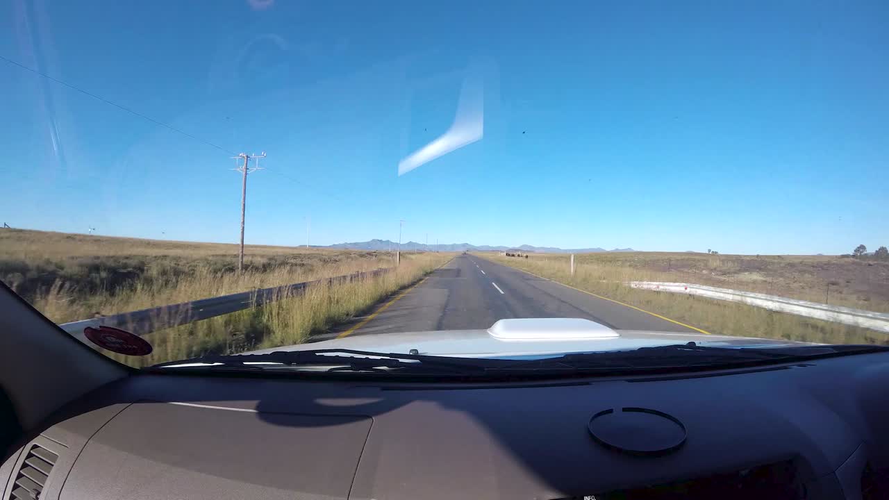 Time lapse of driving vehicle at passengers side with a view of summer green fields