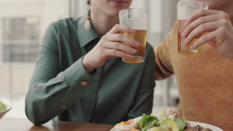 man and woman drinking beer in pub