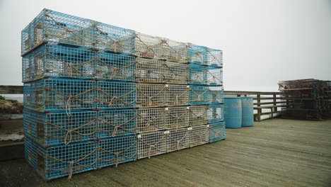 colorful lobster traps stacked on dock pier with other fishing equipment 4k 60p