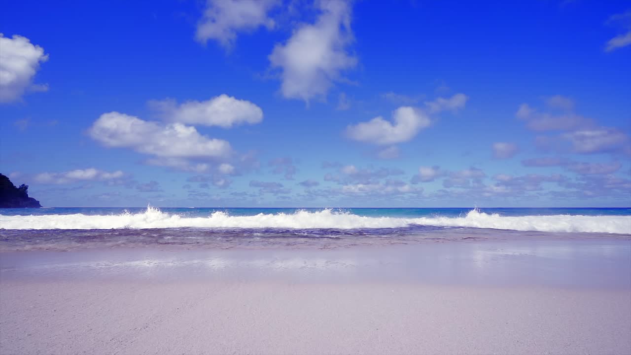 Slow motion of waves crashing on the rocks at anse coral beach, Mahe Seychelles