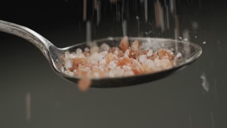 Video-of-cook-throwing-salt-on-the-table-on-black-background