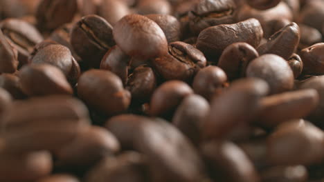 roasted coffee beans falling and rolling in macro and slow motion
