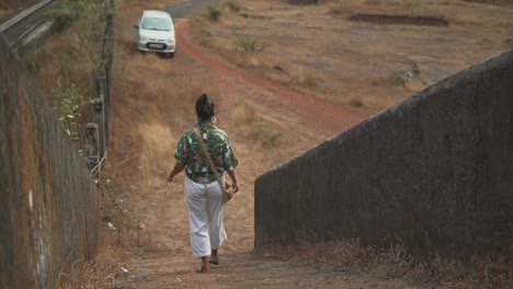 young girl walking down the stairs outdoors and walking into the distance