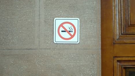 no smoking sign on a brick wall