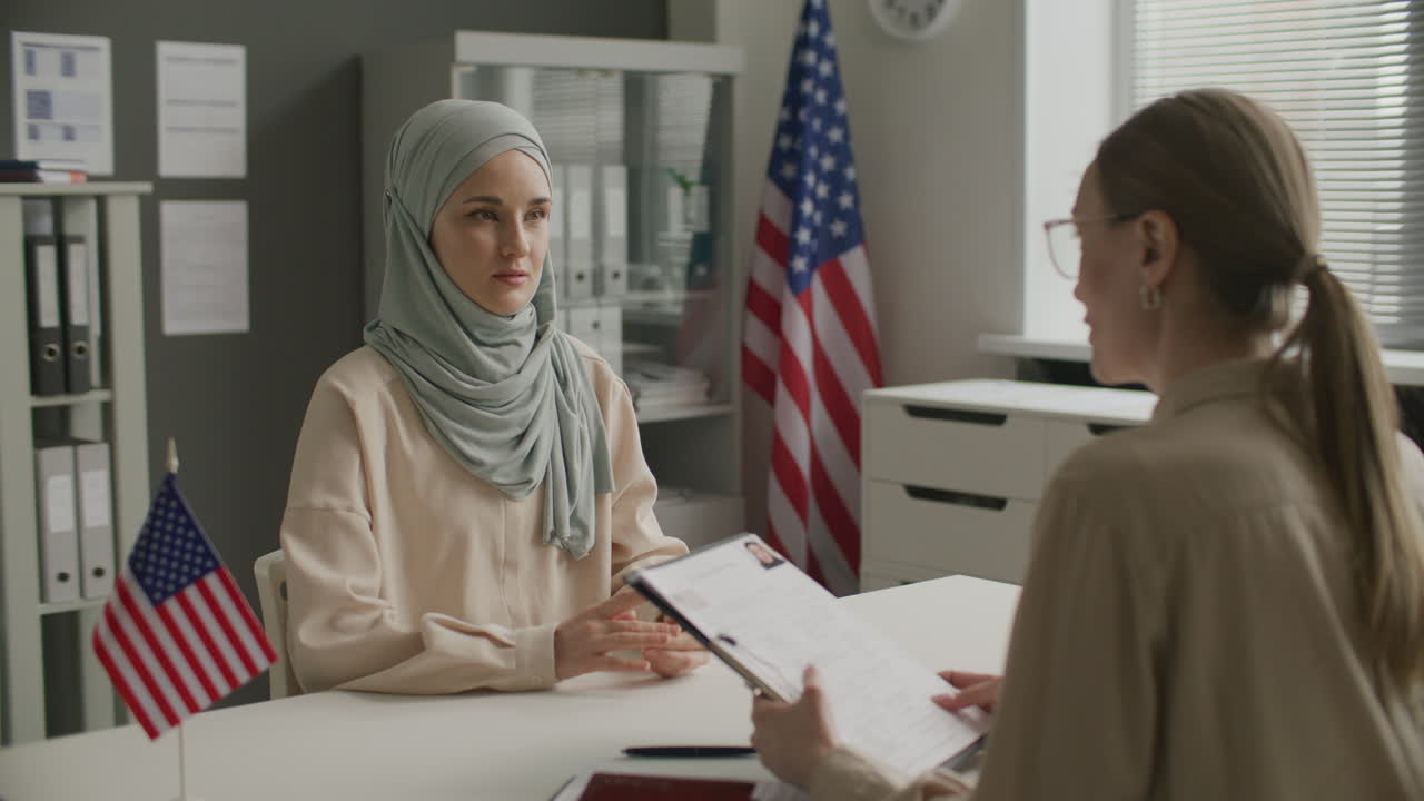 Female Visa Applicant in Hijab Attending Immigration Interview at US Embassy