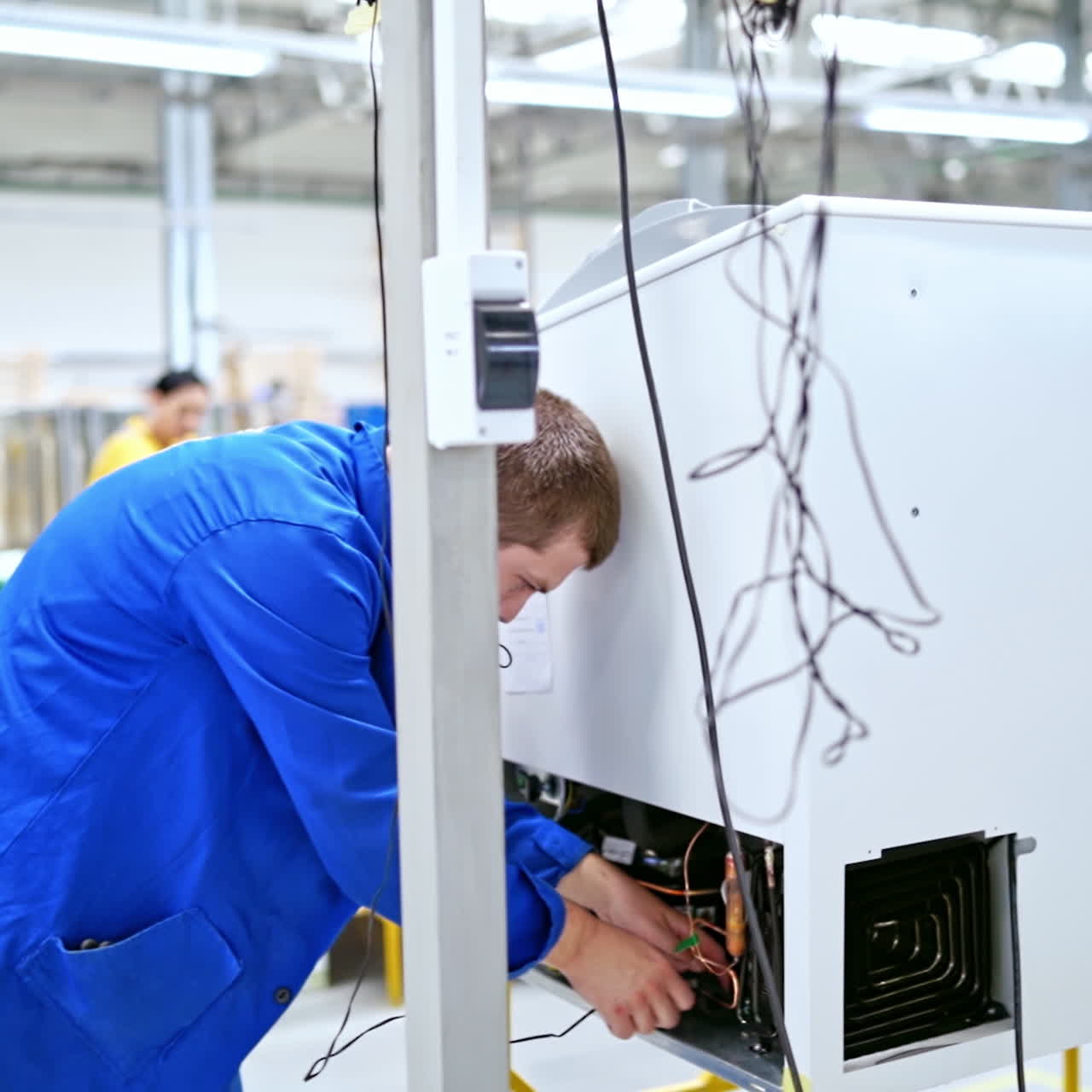 Interior of Industrial working place at factory. Worker at plant in blue uniform checks the production process. Technic concept.
