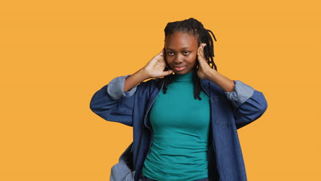 Woman-covering-eyes,-ears-and-mouth-with-hands,-studio-background