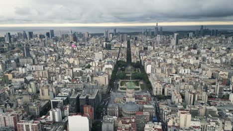 Aerial-Drone-Fly-Above-Congressional-Plaza-Buenos-Aires-Argentina-Cityscape,-City-Town-Architecture-and-Cloudy-Horizon-at-Afternoon-Time