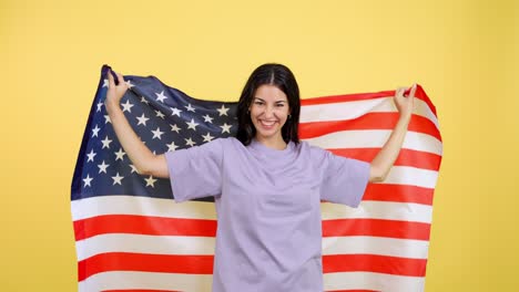 woman wrapped in american flag on yellow background