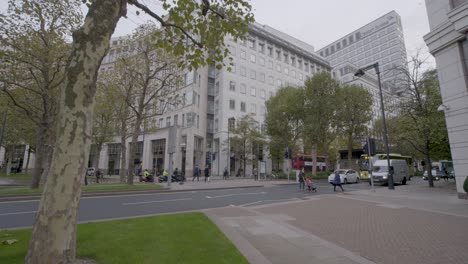busy city street scene in london with credit suisse building