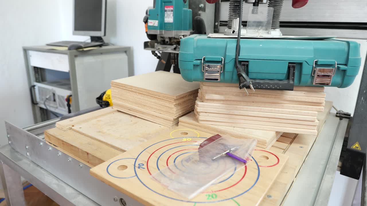 Stacks of boards on table of computer controlled power tool for carving wood