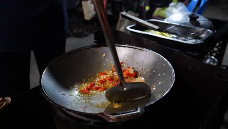 stir-frying ingredients in a wok