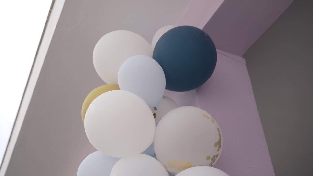 minimalist balloon decoration in soft colors for festive indoor celebration
