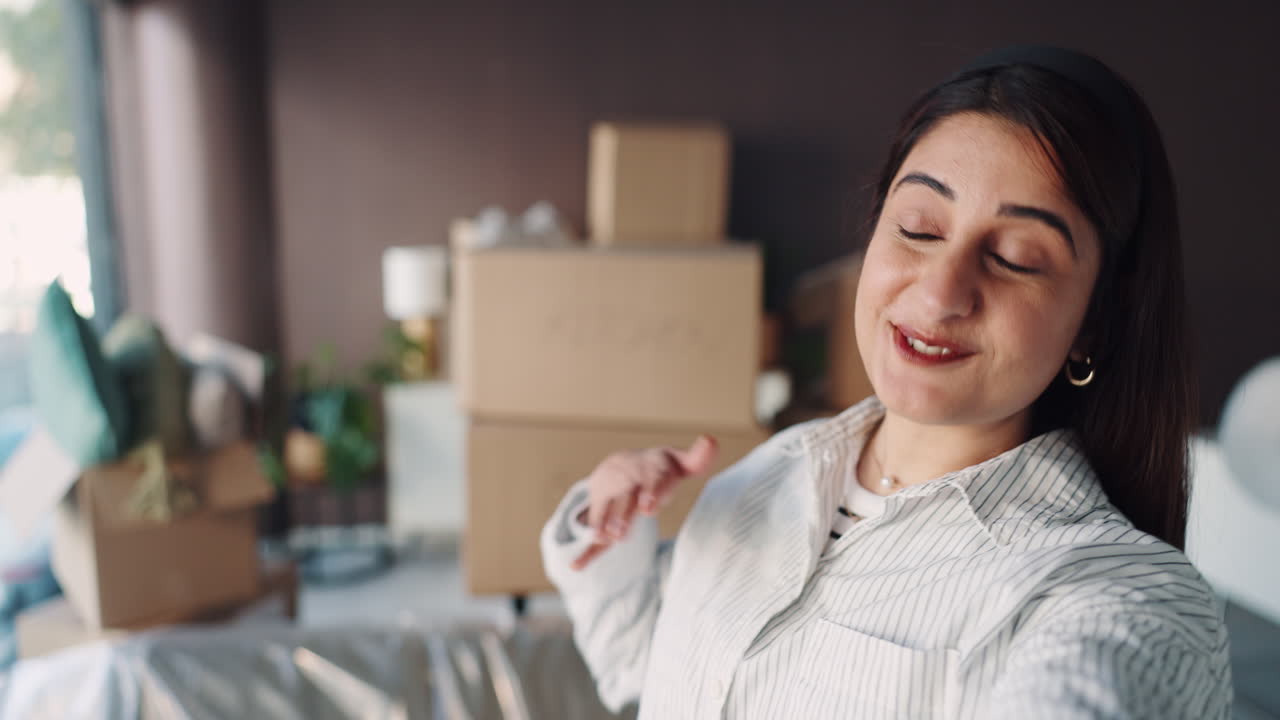 Woman in new home with moving boxes
