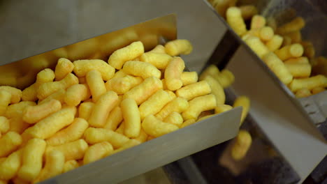 corn puffs on a conveyor belt