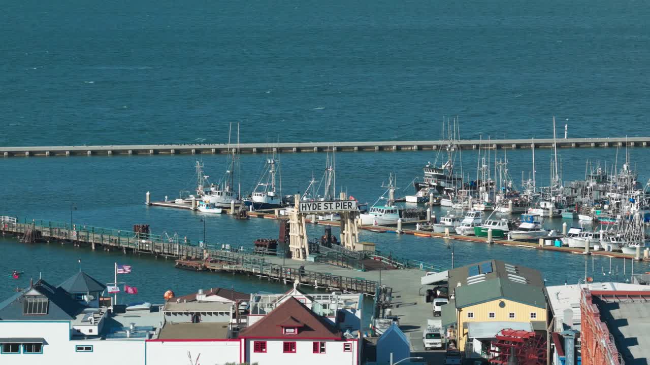 Aerial telephoto shot of historic Hyde Street Pier at Fisherman's Wharf in San Francisco, California. 4K