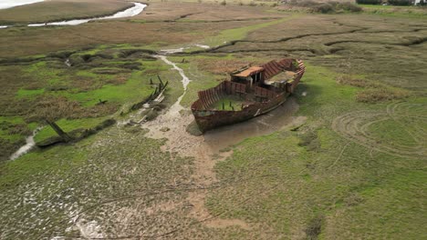 Rusted-ship-carcass-on-muddy-salt-marsh-at-Fleetwood-Marshes-Nature-Reserve