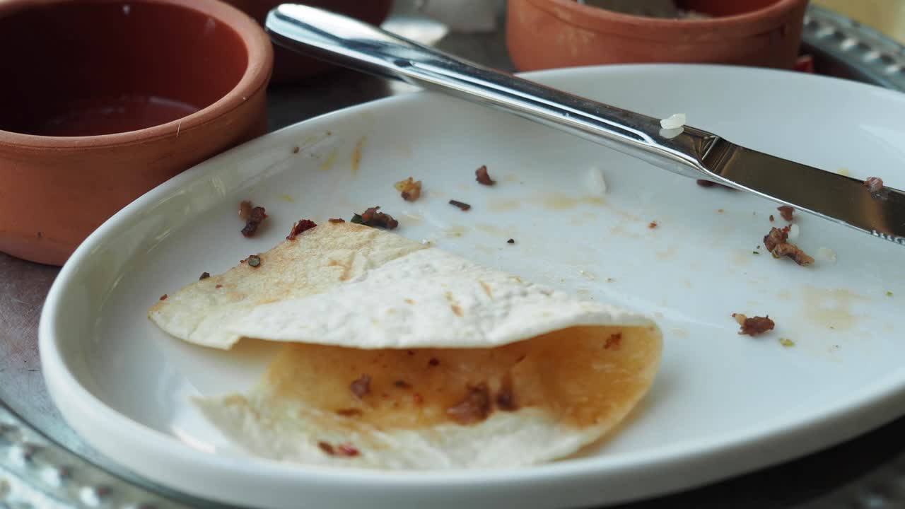 Empty plate with leftover tortilla and scraps