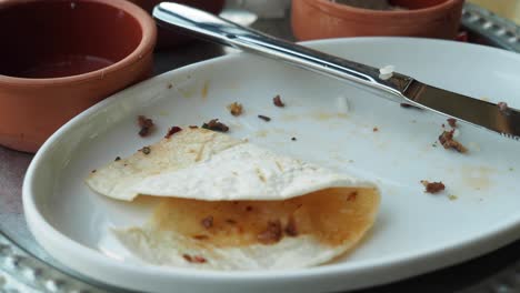 empty plate with leftover tortilla and scraps