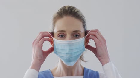 Female-health-worker-wearing-face-mask-at-home