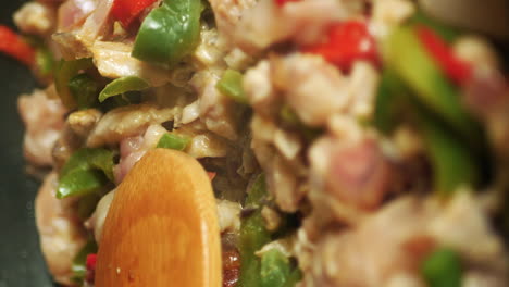 Wooden-spoon-rests-on-cooking-ingredients-in-preparation-of-tasty-homemade-fajitas