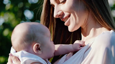 Close-up of a happy mother holding her baby