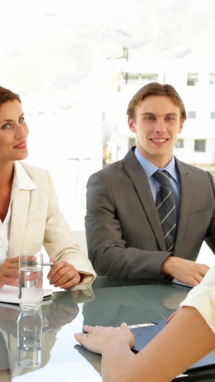 Businesswoman being interviewed by panel and being offered the job
