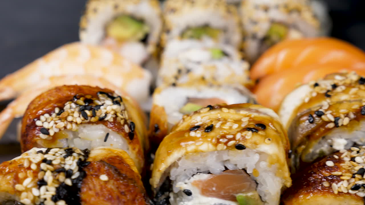 Healthy and delicious rolls of sushi on black stone