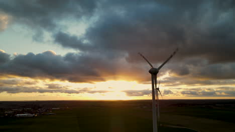 wind turbine spinning in scenic sunset view - wide shot