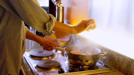 woman preparing food in kitchen 4k