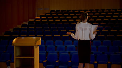 young caucasian businesswoman practicing speech in empty auditorium 4k