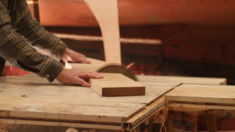 Oak board cut smoothly with a table saw in a professional boat building workshop