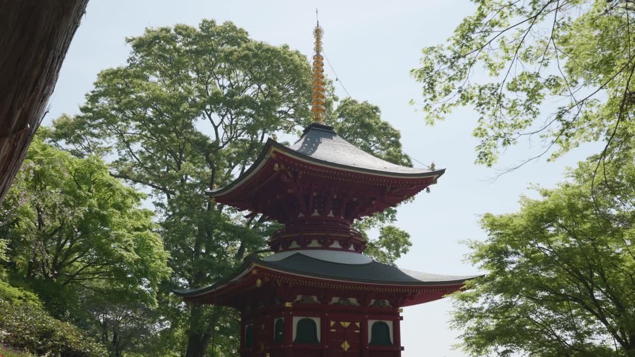 Red pagoda in nature on a sunny day in Katsuoji Temple, Osaka, Japan