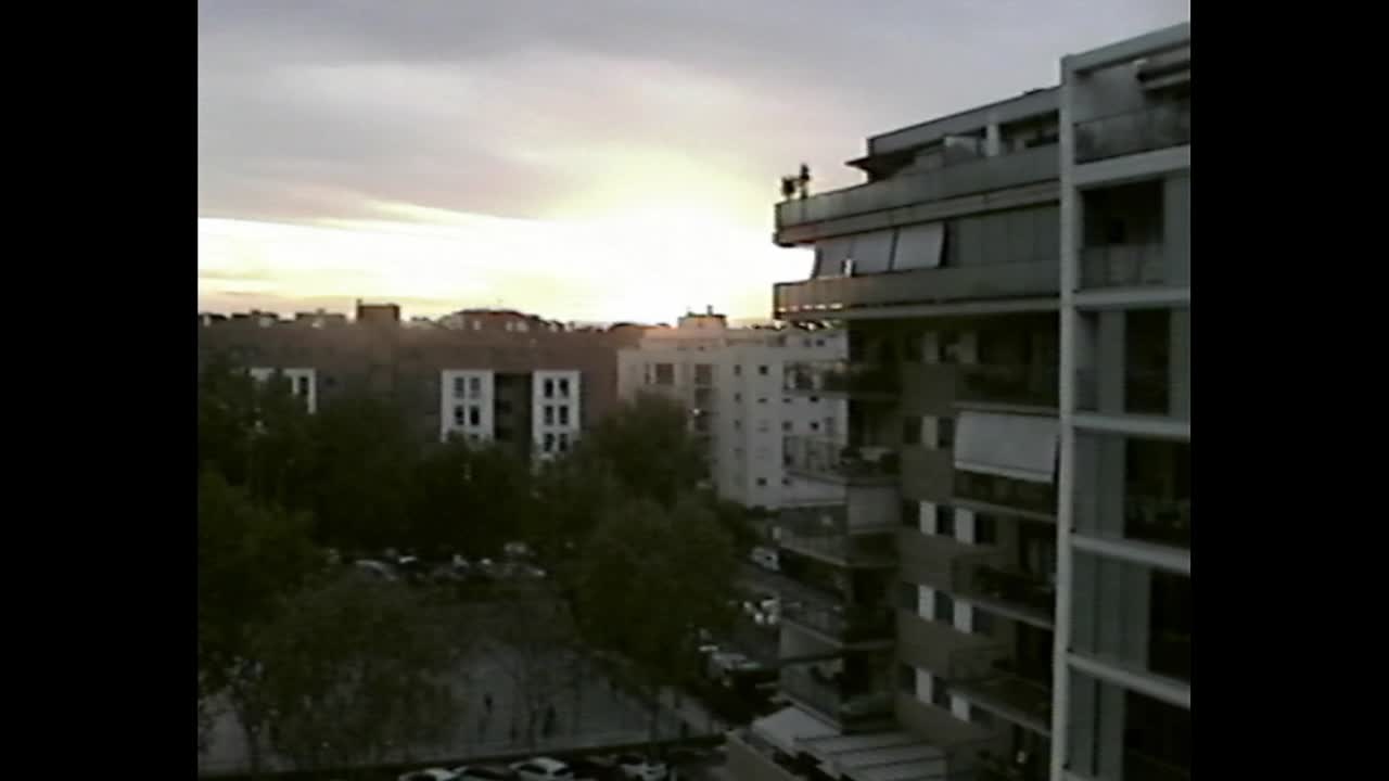 Sunset behind city buildings and antenna