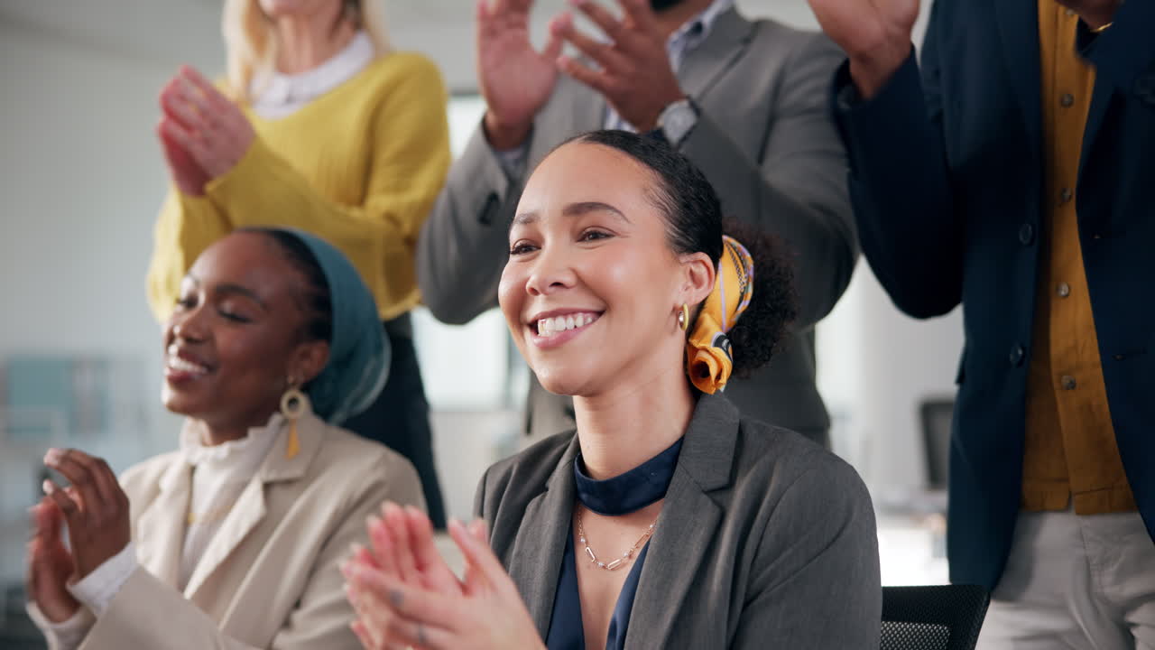 Business professionals applauding in a meeting