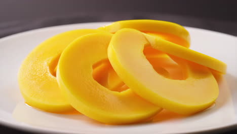 canned peach slices on a white plate