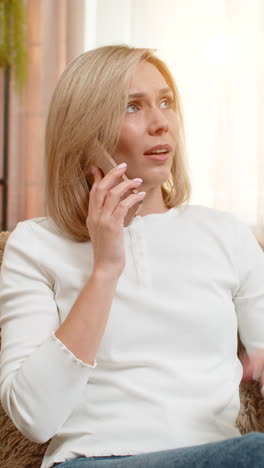 woman experiences various emotions during a phone call at home
