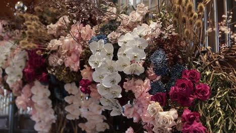 flower arrangement with white orchids, red - pink roses