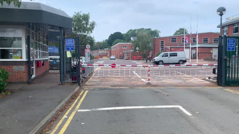 security gate entrance with a barrier at the entry of a business building establishing shot