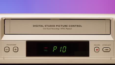 vintage vcr with hand inserting tape