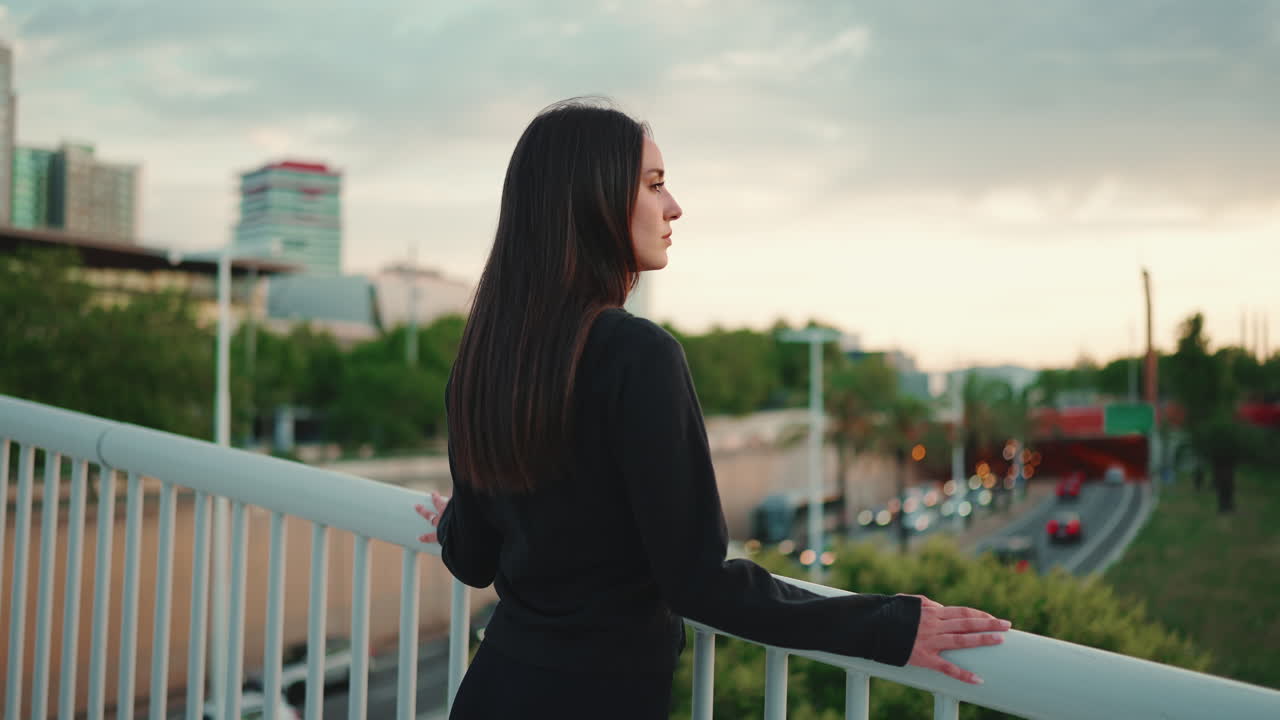Woman Looking at City View from Bridge