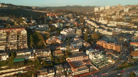 Aerial-view-flying-over-scenic-Reñaca-beach-resort-hotel-buildings-on-Vina-Del-Mar-waterfront,-Chile