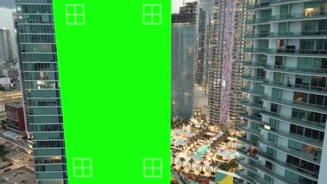 Empty-billboard-green-screen-on-skyscraper-building-for-advertising-with-tracking-markers